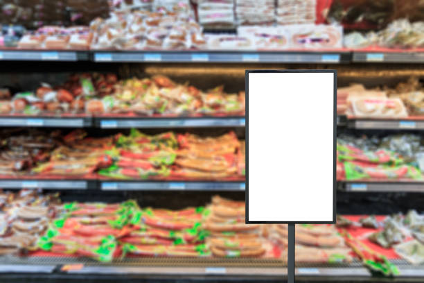 istock Blank billboard and blurred supermarket ham sausage background 869943182