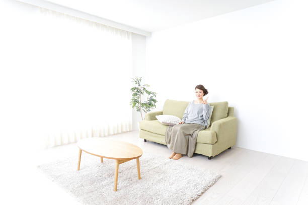 istock Woman pointing to something at home 869943986