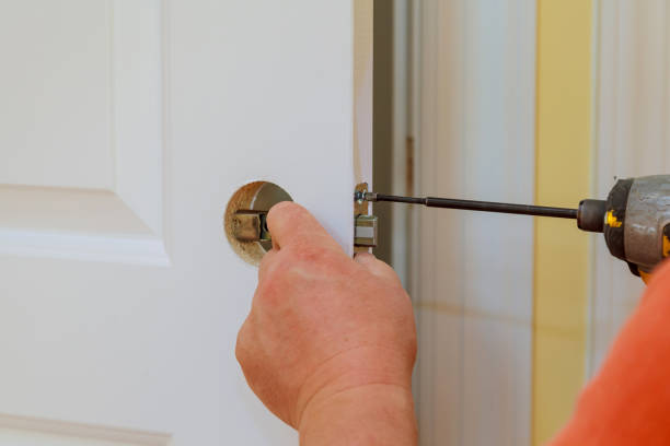 istock carpenter at lock installation with electric drill wood door 869953648