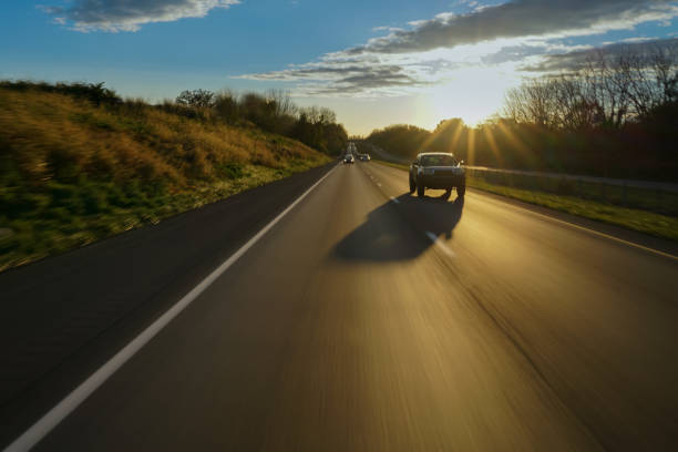 Car on open road at suset