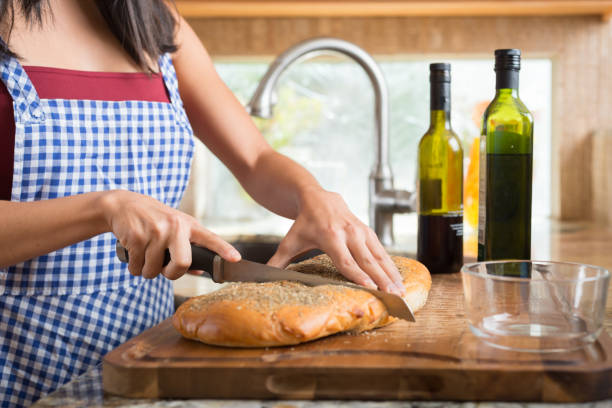 Hispanic Women In The Kitchen Baking Bread