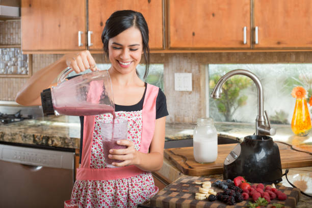 istock Hispanic Women In The Kitchen Making Smoothies 869960794