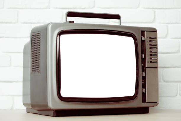 istock Old television with cut out screen on a white brick wall background. 869960936