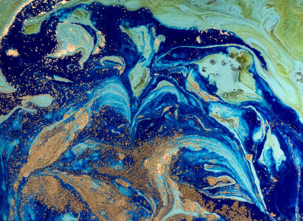 istock Marbled green and blue abstract background with golden sequins. Liquid marble ink pattern. 869963650
