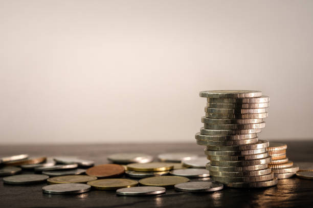 istock Coins money stacked on black granite table 869973634
