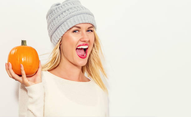 istock Young woman holding pumpkins 869973714