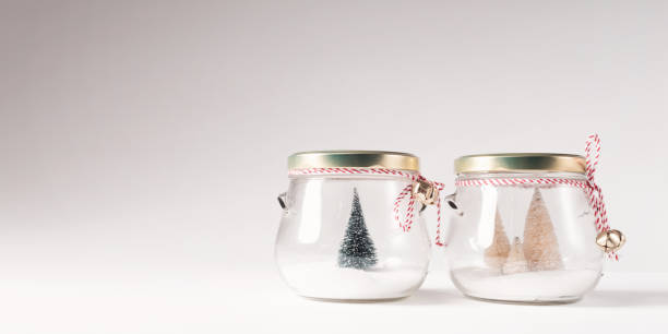 istock Small Christmas trees in glass jars 869977040