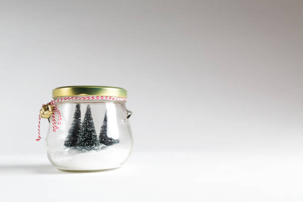 istock Christmas trees in a glass jar 869977050