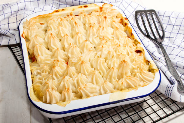 home made traditional irish fish pie home made traditional irish fish pie in an blue and white enamel bowl fish pie stock pictures, royalty-free photos & images