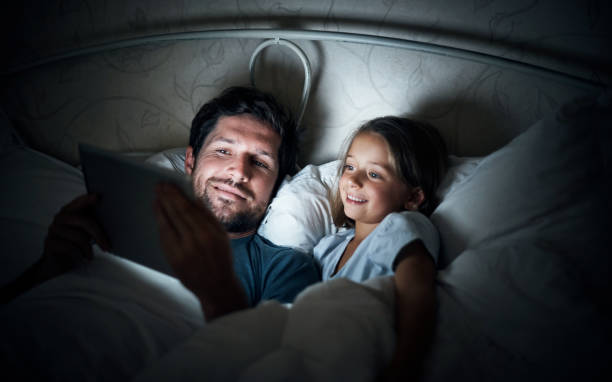 istock Snuggling up with a digital bedtime story 869981686