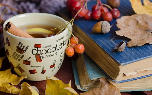 Cup of tea and autumn leaves, nuts, and berries