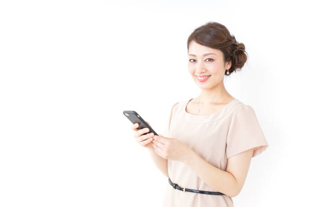 woman in dress using a smartphone