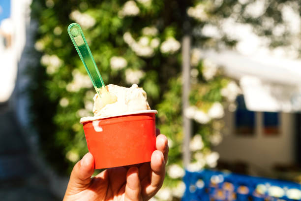 istock Close-up of hand holding ice cream cup 869984828