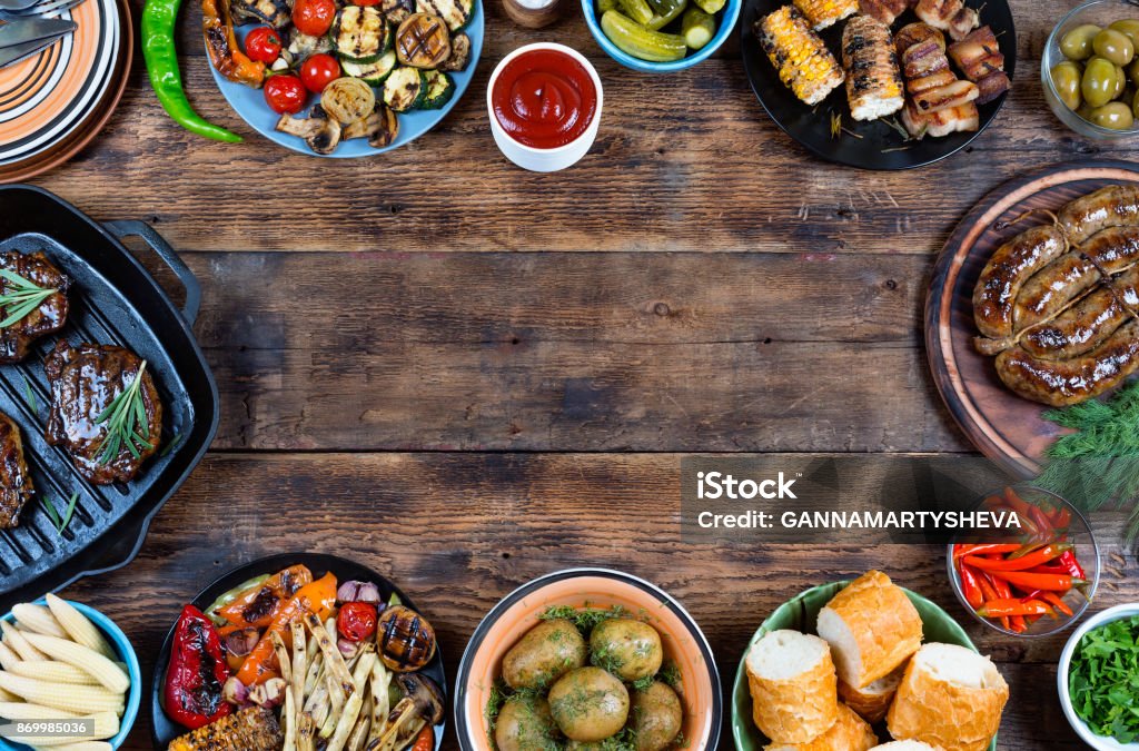 Food frame and barbecue dishes. Food frame and barbecue dishes. The concept of eating outdoors outside the home. Summer time. Top - Garment Stock Photo