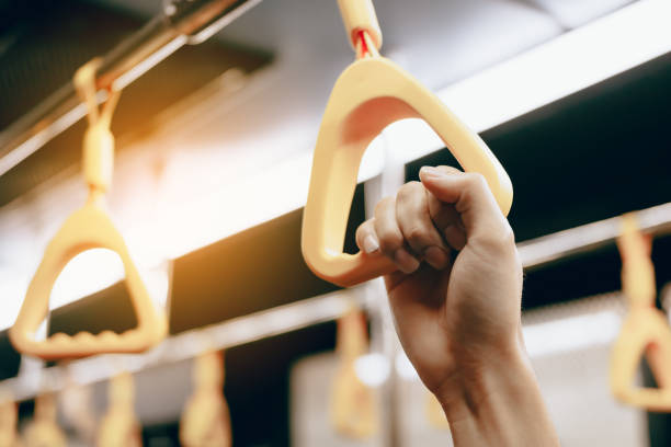 Young passenger woman hand holding handrail in subway.