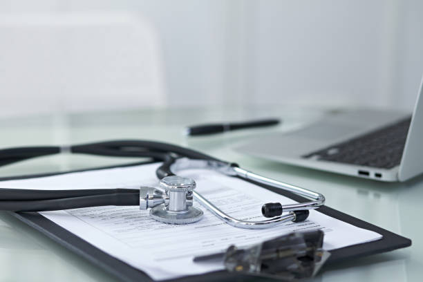 istock Medicine doctor's working table. Focus on stethoscope 869991854