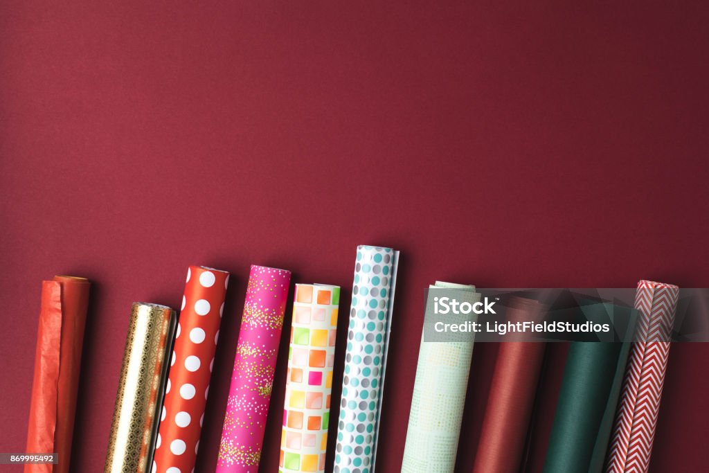 rolls of wrapping paper flat lay with arranged colorful rolls of wrapping paper on tabletop Wrapping Paper Stock Photo