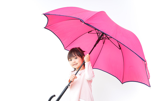 A child opening an umbrella