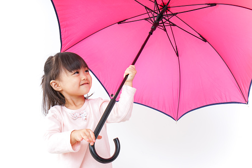 A child opening an umbrella