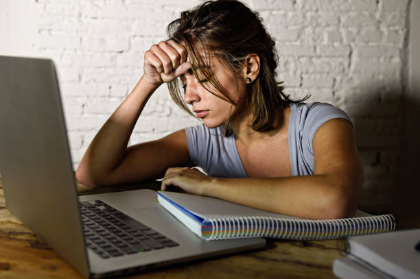 istock young student girl studying tired at home laptop computer preparing exam exhausted and frustrated feeling stress and bored lying lazy on desk 870009406