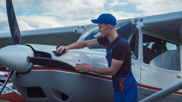 istock Young pilot or mechanic working on an aircraft 870011730
