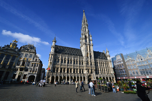 Brussels: Tourists visiting the Town Hall of the City of Brussels, a building of gothic architectural style from the middle ages located at the Grand Place in Brussels, Belgium