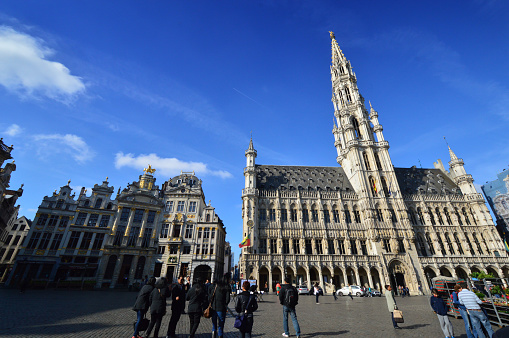Brussels: Tourists visiting the Town Hall of the City of Brussels, a building of gothic architectural style from the middle ages located at the Grand Place in Brussels, Belgium