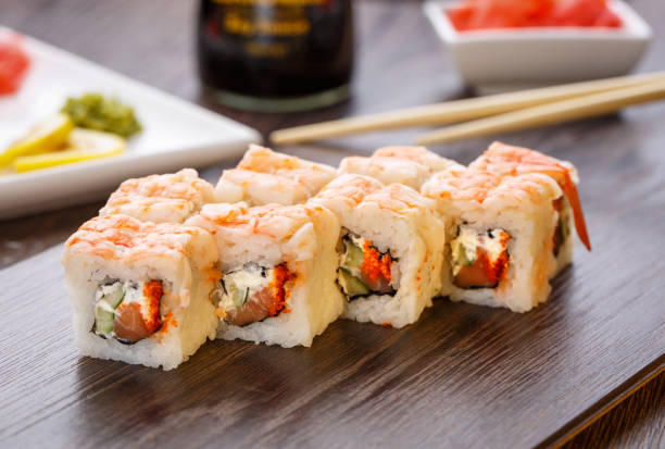 istock Sushi rolls served on wooden slate 870016694