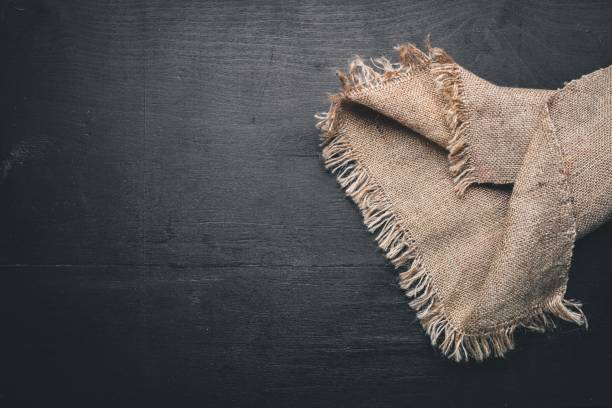 istock Old linen fabric. On Wooden table. Top view. 870020448