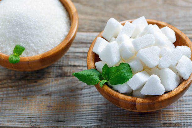 istock White figured sugar in a wooden bowl. 870025982