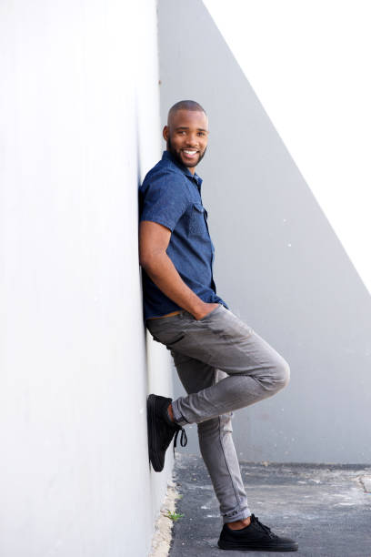 istock Full length stylish young black standing by wall 870026492
