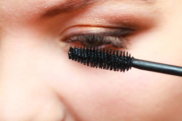 istock Close up woman getting make up, mascara 870030100
