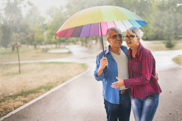 istock Senior couple with a rainbow umbrella 870030644