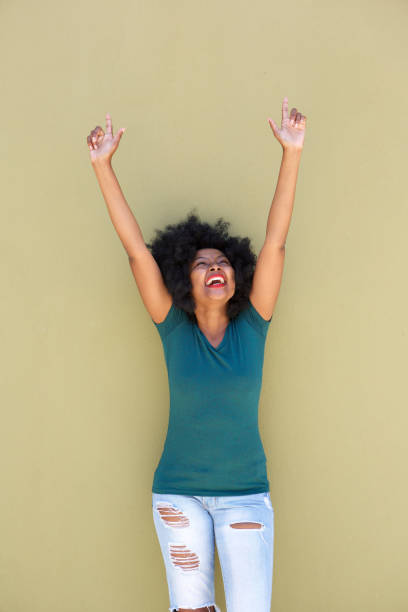 istock successful beautiful woman with outstretched arms smiling 870041320