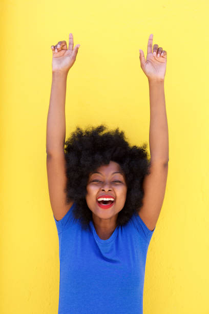 istock beautiful woman smiling with arms raised 870041412