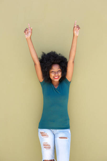 istock cheerful black woman smiling with outstretched arms 870041504
