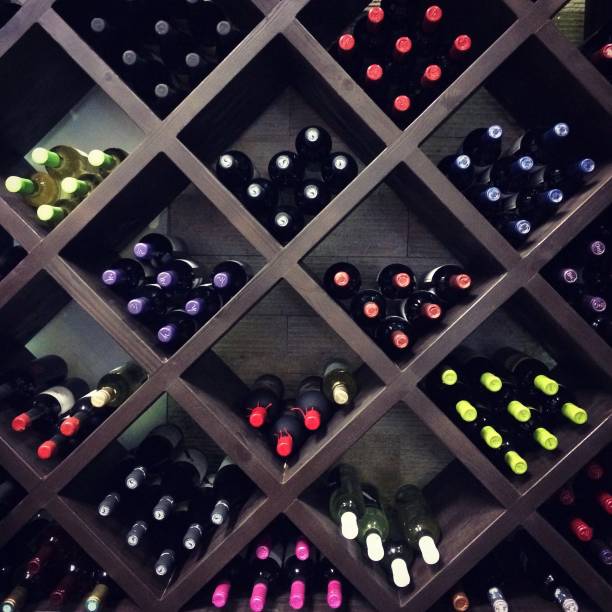 Wine bottles on the shelves stock photo