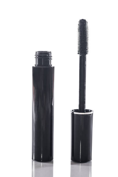 istock Black mascara with applicator brush isolated on white 870048792