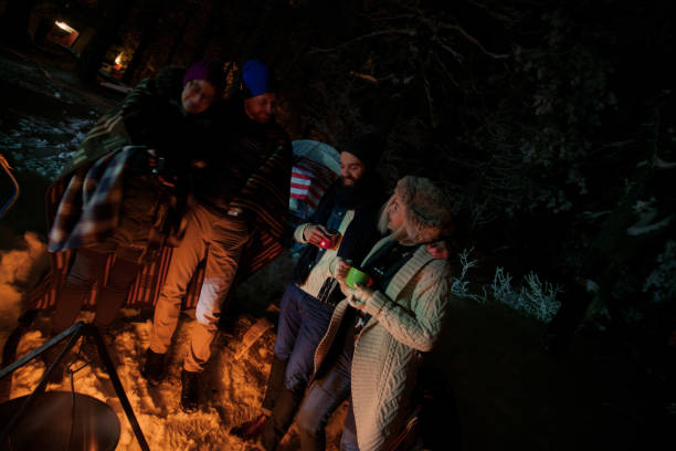 istock Friends camping on snowy mountain 870049304
