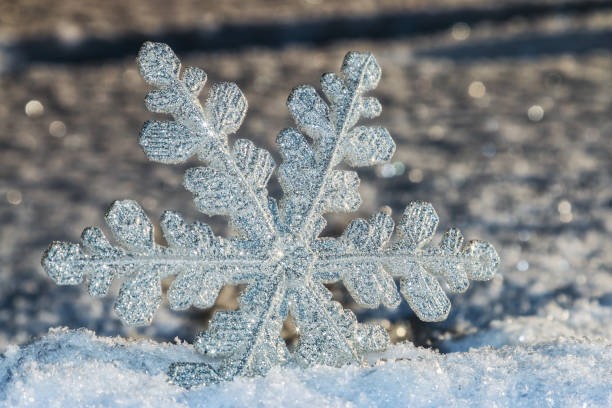 istock decorative snowflake sticking out of the snow 870050208