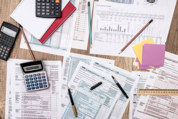 istock saving concept - tax form, budget, notepad, pen, calculator 870050384