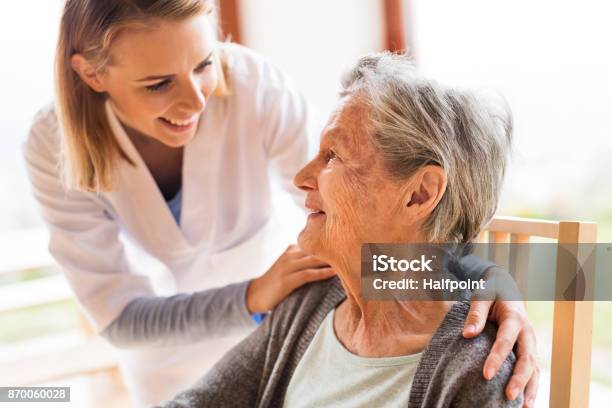 Health Visitor And A Senior Woman During Home Visit Stock Photo - Download Image Now