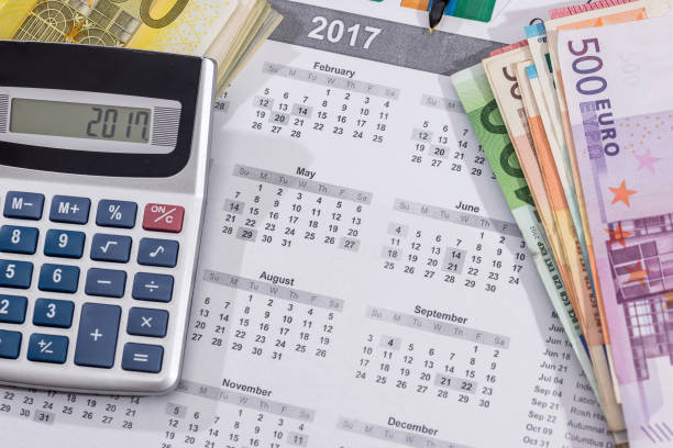 istock 2017 calendar with euro bills with calculator pen 870060252