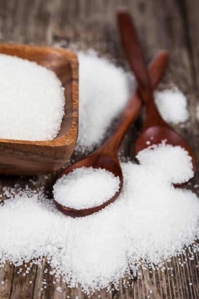 istock Sugar in a wooden bowl and  two spoons 870060510