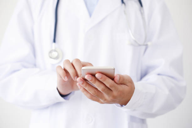 istock Doctor hands with smartphone 870064222