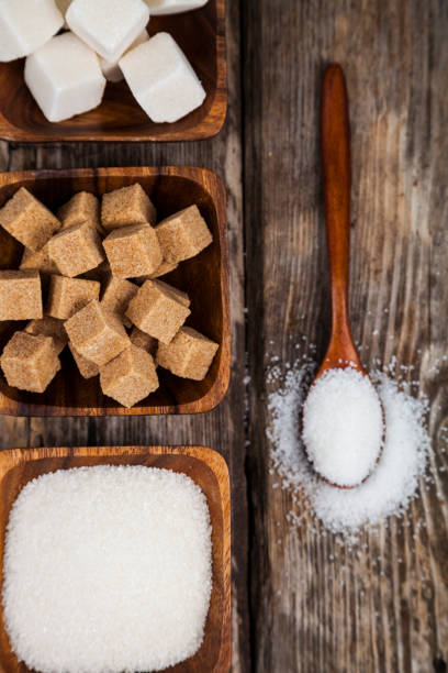 istock Sugar in a wooden bowls and a spoon 870067656