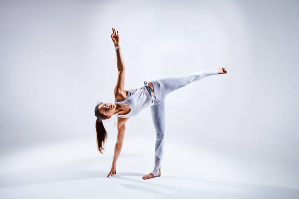 istock Woman doing yoga isolated on white background 870072938