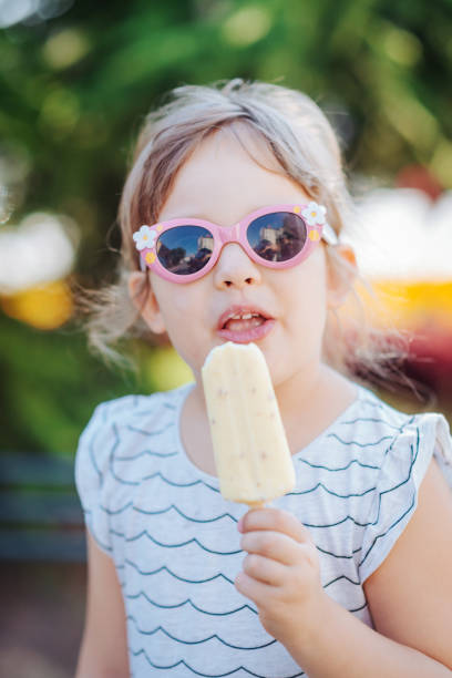 istock Young girl eating ice-cream in summer 870073412