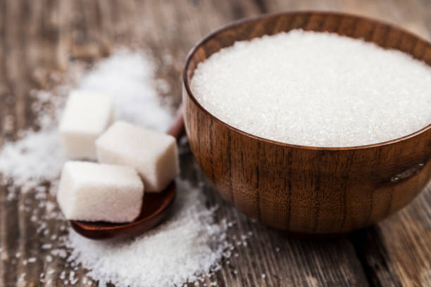 istock Sugar in a wooden bowl and a spoon 870075934
