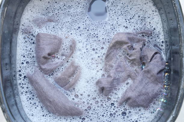 istock gray shirt soak in detergent water dissolution on plastic basin 870076816
